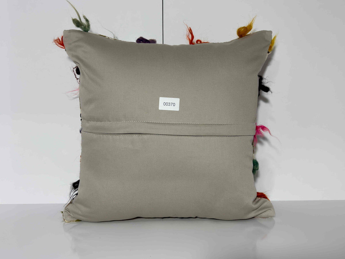 Close-up of the white Turkish kilim pillow showing traditional details.