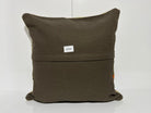 Close-up of the beige Turkish kilim pillow showing striped details.