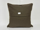 Close-up of the beige Turkish kilim pillow showing traditional details.