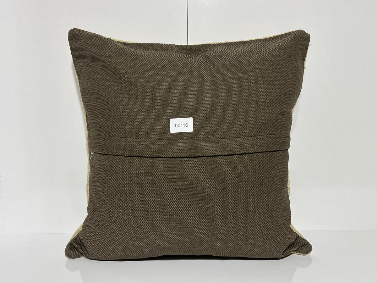 Close-up of the beige Turkish kilim pillow showing traditional details.