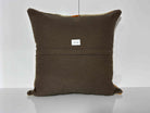 Close-up of the beige Turkish kilim pillow showing striped details.