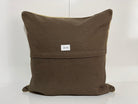 Close-up of the beige Turkish kilim pillow showing striped details.