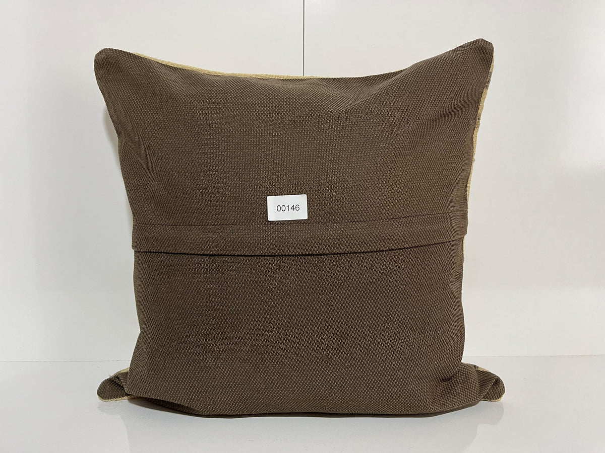 Close-up of the beige Turkish kilim pillow showing striped details.