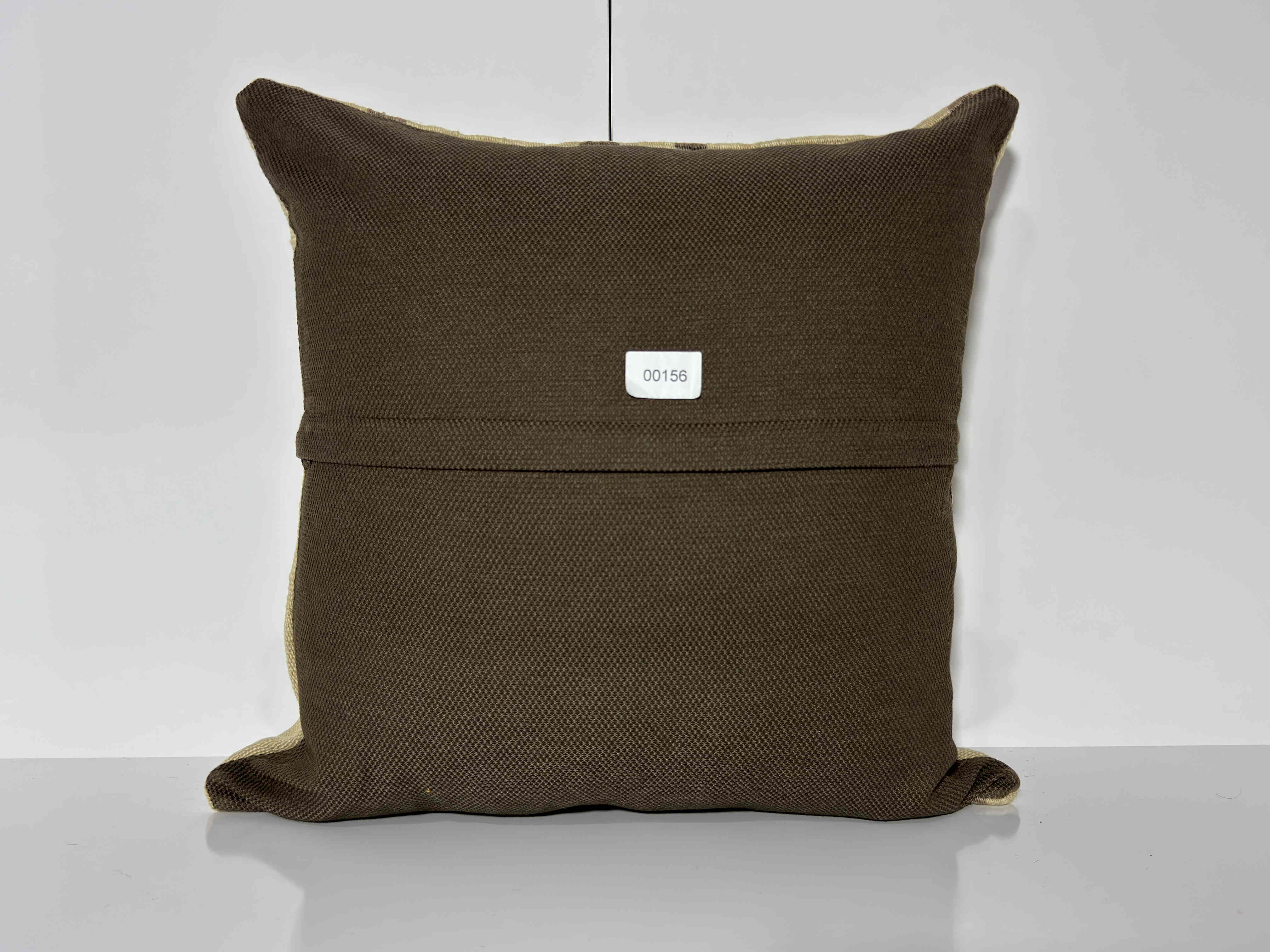 Close-up of the beige Turkish kilim pillow showing striped details.