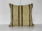 Beige Turkish kilim pillow, shown on the floor.