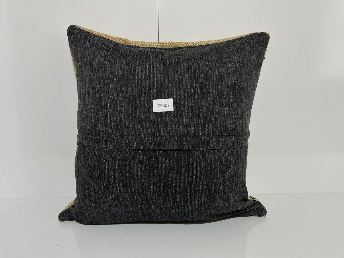 Close-up of the beige Turkish kilim pillow showing geometric details.