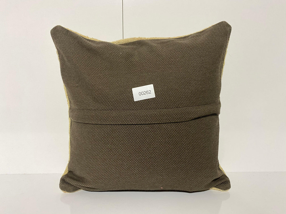 Close-up of the beige Turkish kilim pillow showing traditional details.