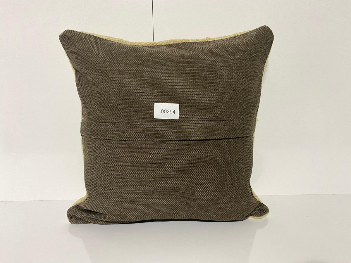 Close-up of the beige Turkish kilim pillow showing traditional details.