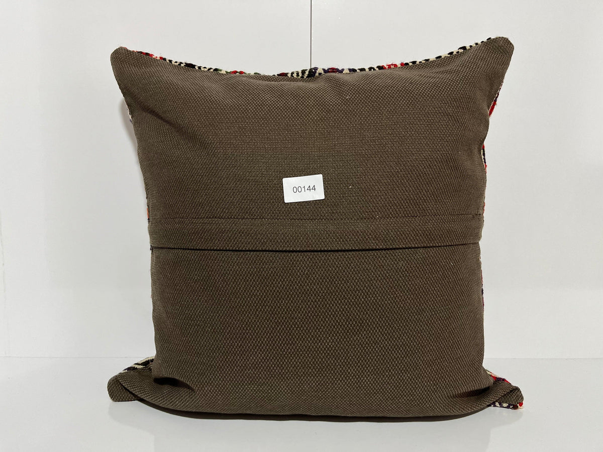 Close-up of the black Turkish kilim pillow showing traditional details.