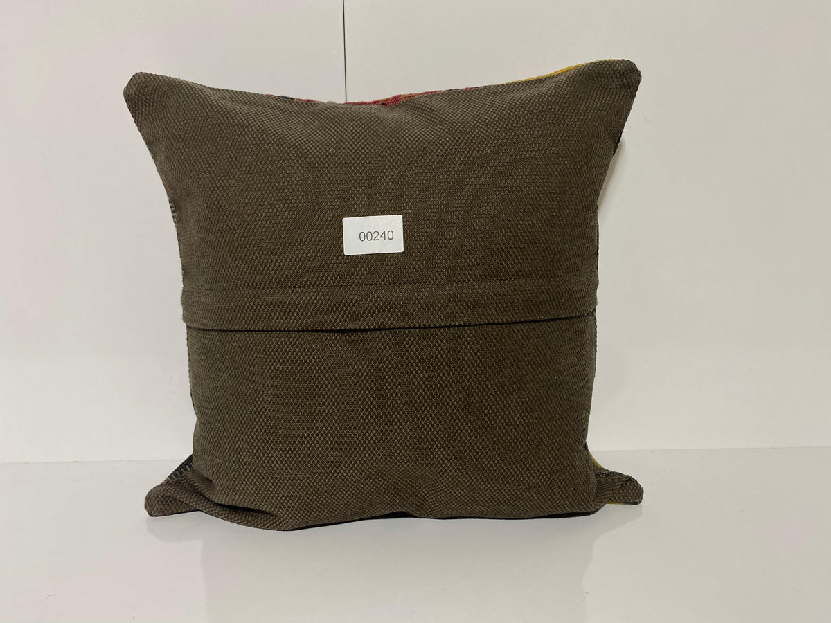 Close-up of the black Turkish kilim pillow showing traditional details.