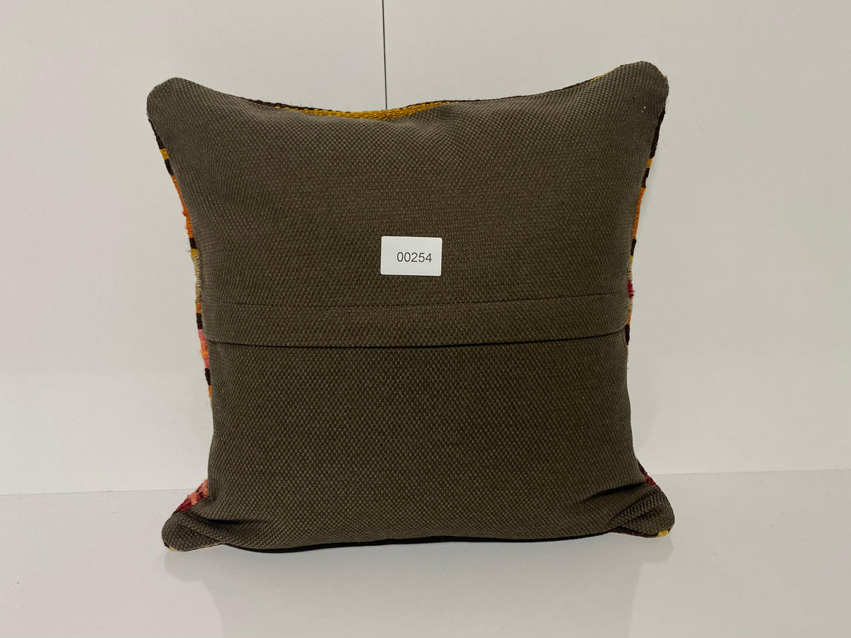 Close-up of the black Turkish kilim pillow showing traditional details.