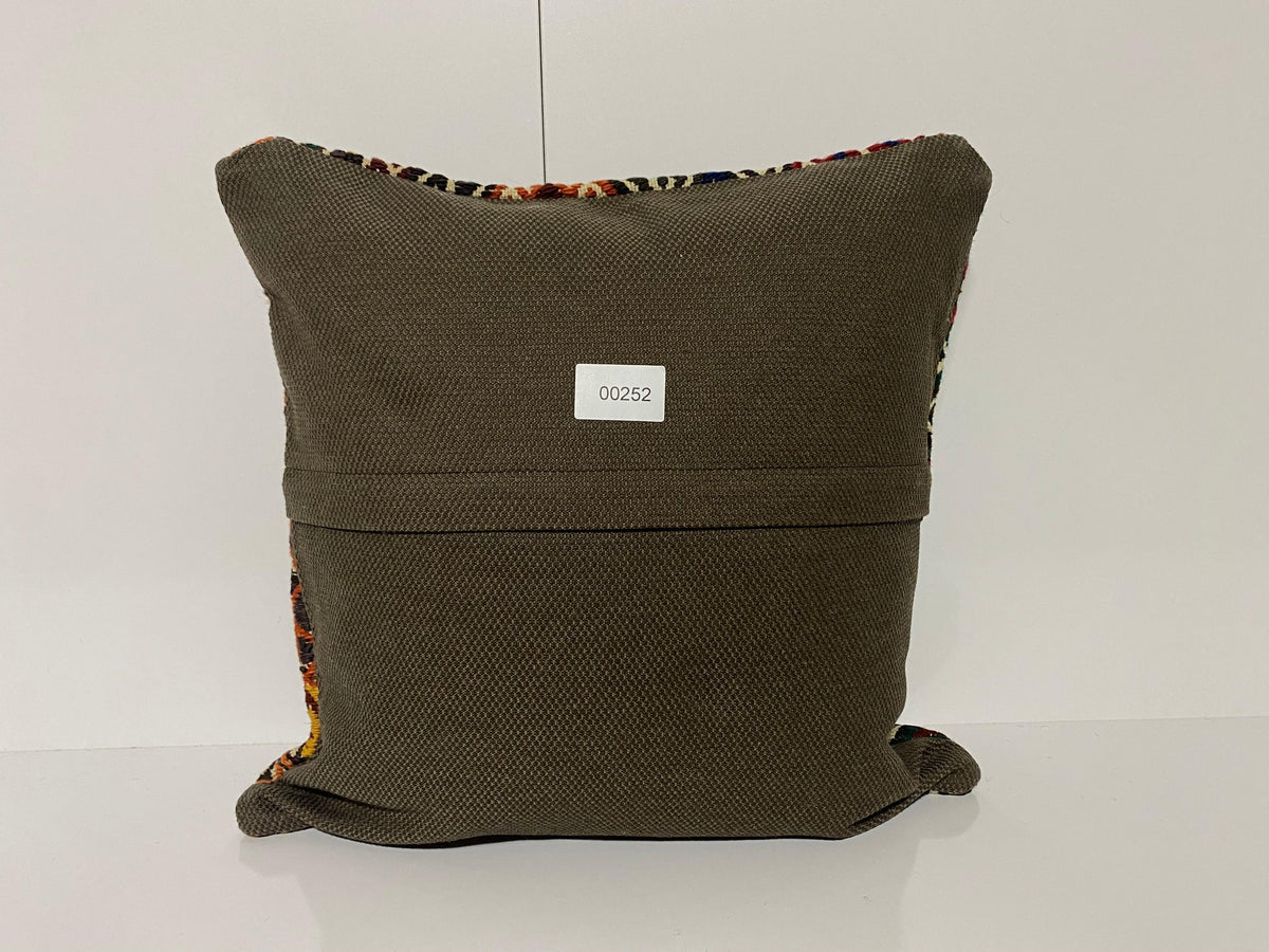 Close-up of the blue Turkish kilim pillow showing geometric details.