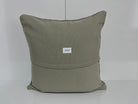 Close-up of the gray Turkish kilim pillow showing traditional details.