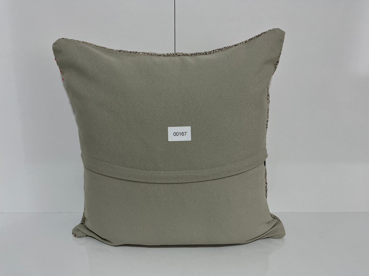 Close-up of the gray Turkish kilim pillow showing traditional details.