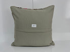 Close-up of the gray Turkish kilim pillow showing traditional details.