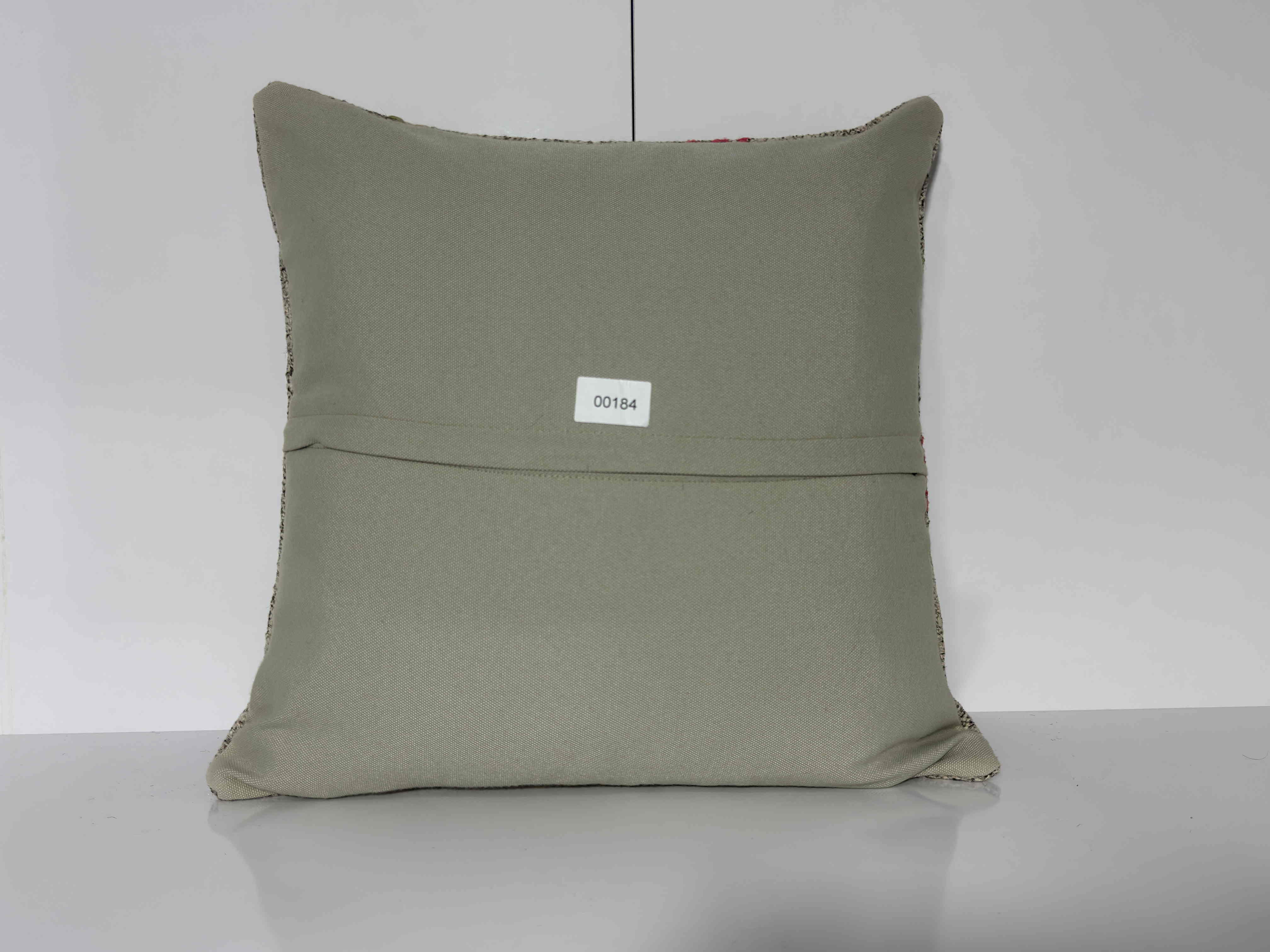 Close-up of the gray Turkish kilim pillow showing traditional details.