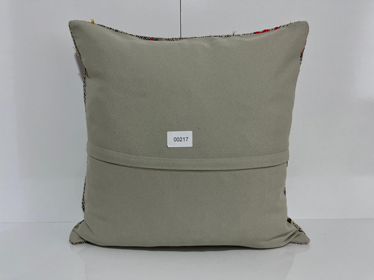 Close-up of the gray Turkish kilim pillow showing traditional details.