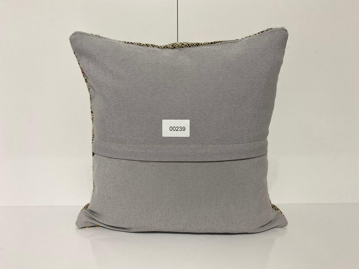 Close-up of the gray Turkish kilim pillow showing traditional details.
