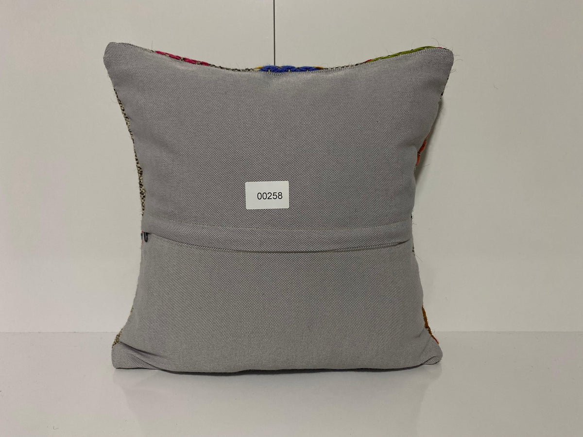 Close-up of the gray Turkish kilim pillow showing traditional details.