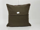 Close-up of the green Turkish kilim pillow showing geometric details.
