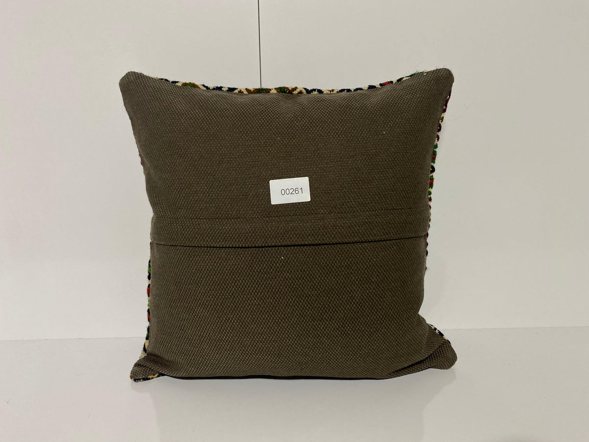 Close-up of the green Turkish kilim pillow showing geometric details.
