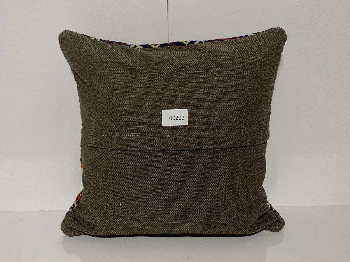 Close-up of the green Turkish kilim pillow showing geometric details.