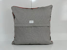 Close-up of the orange Turkish kilim pillow showing traditional details.