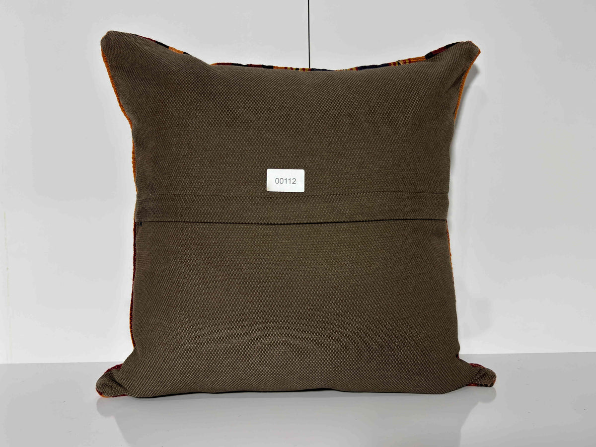 Close-up of the orange Turkish kilim pillow showing striped details.
