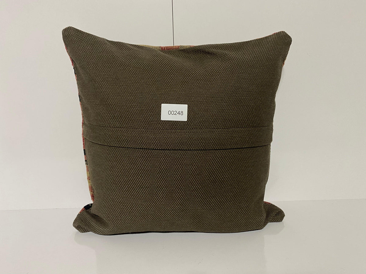 Close-up of the red Turkish kilim pillow showing traditional details.