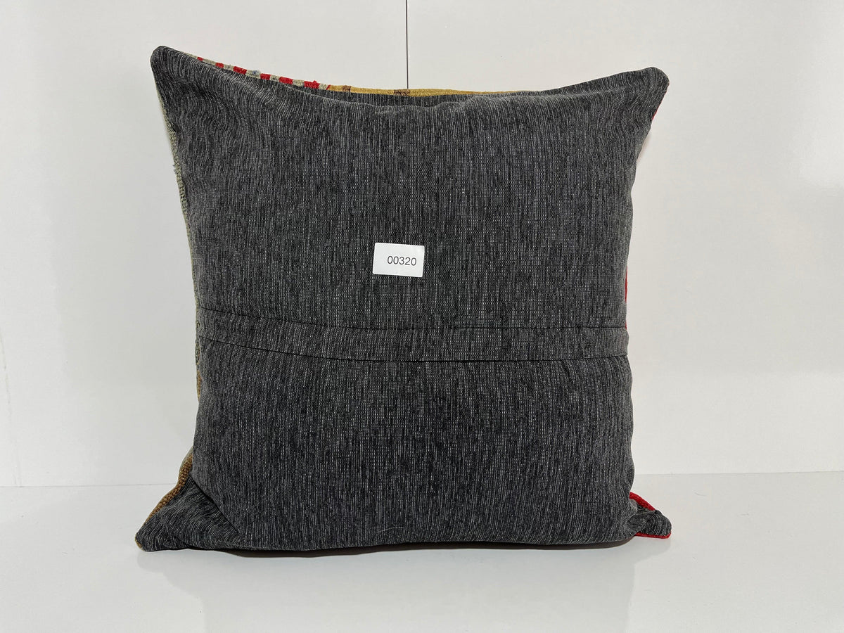 Close-up of the yellow Turkish kilim pillow showing traditional details.
