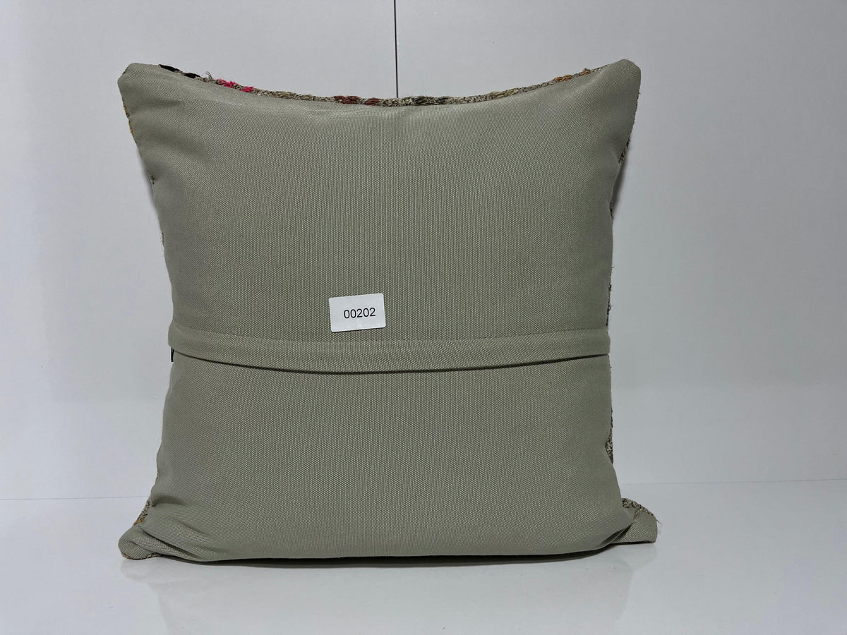 Close-up of the gray Turkish kilim pillows showing traditional details.