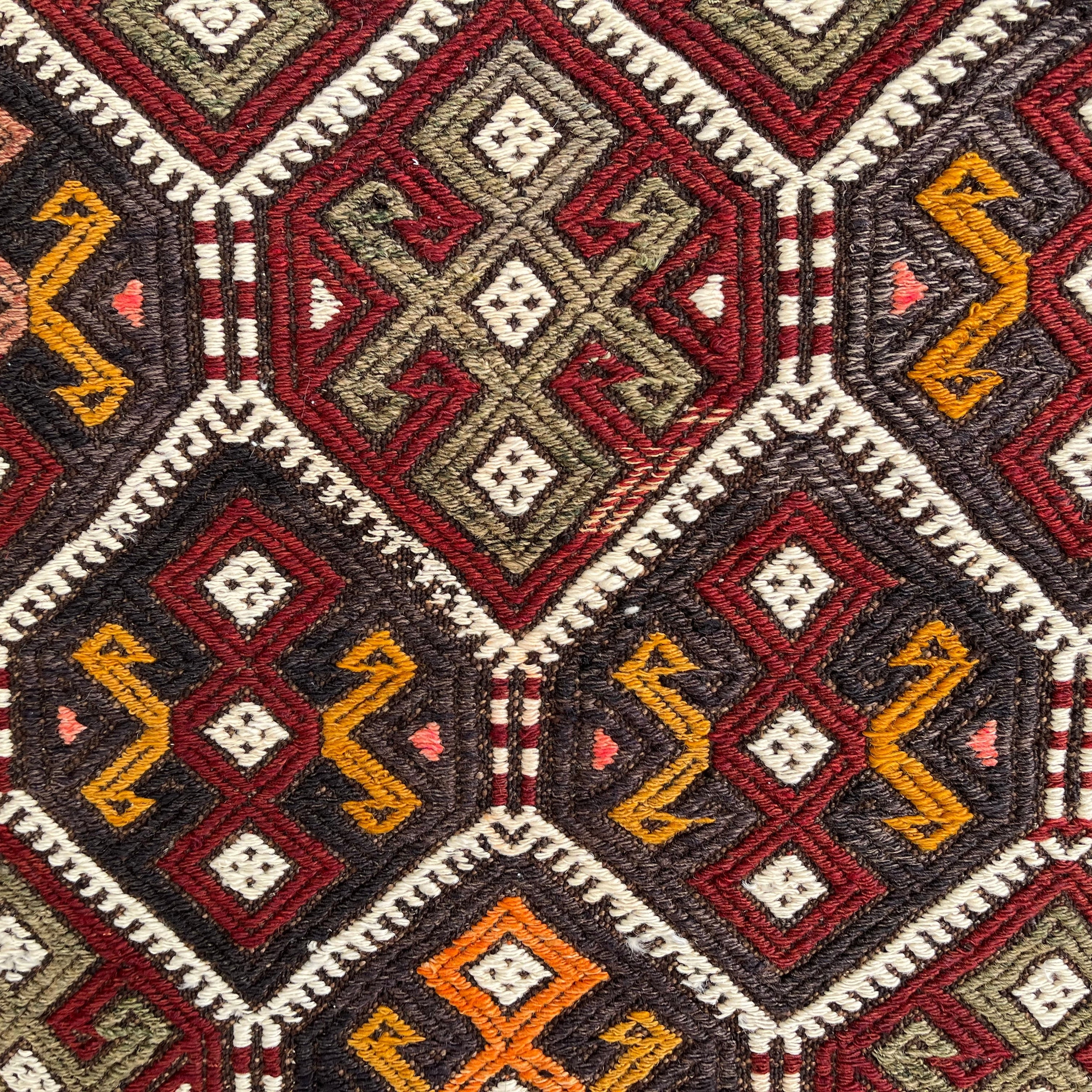 Orange 2' x 4' Turkish kilim rug in wool and cotton, shown on the floor.
