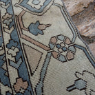 Close-up of the pale blue Turkish large area rug showing traditional details, hand-knotted weave, wool and cotton and low pile.