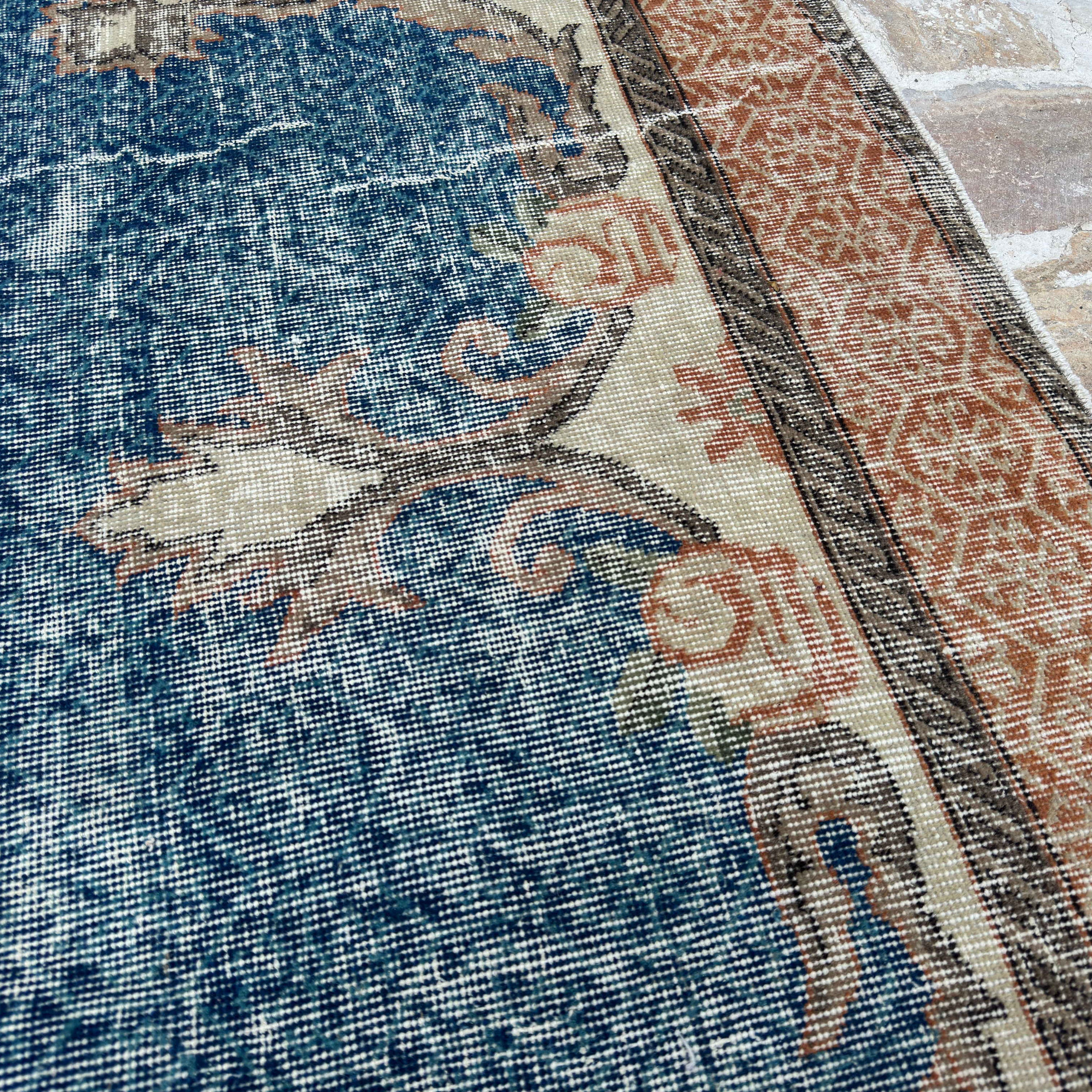 Close-up of the blue Turkish large medallion rug showing medallion details, hand-knotted weave, wool and cotton and low pile.