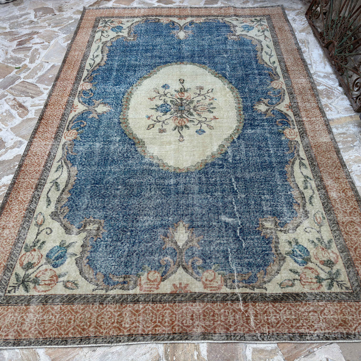 Blue 7' x 10' Turkish large medallion rug in wool and cotton, shown on the floor.