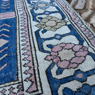 Close-up of the blue large turkish rug showing traditional details, hand-knotted weave, wool and cotton and low pile.