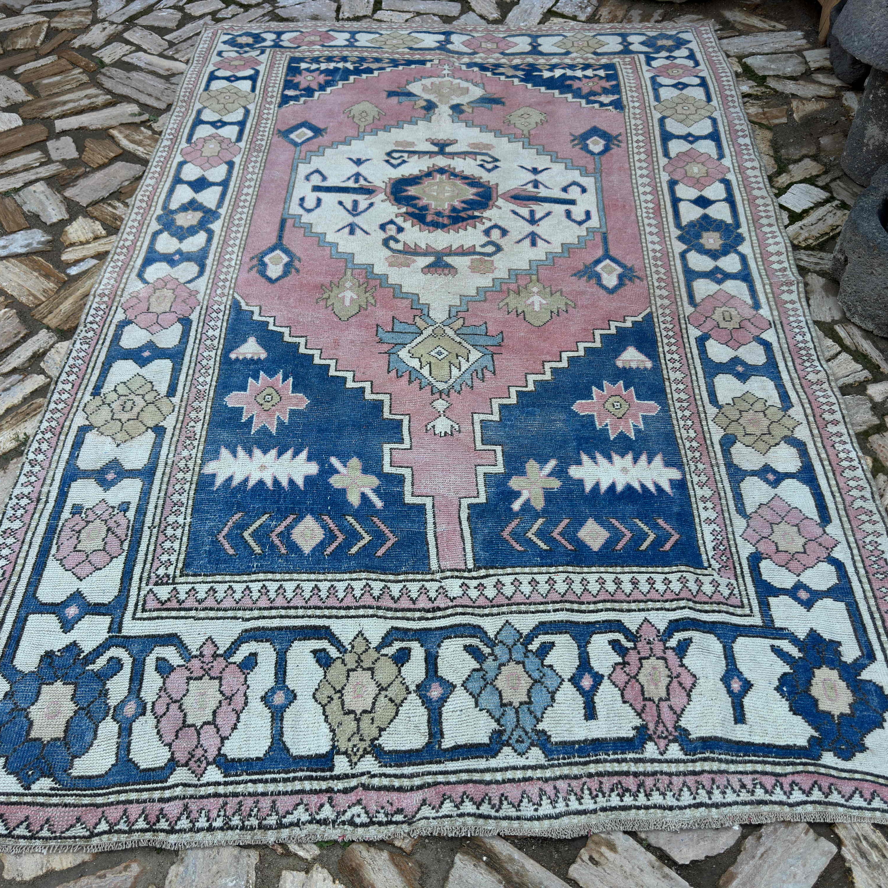 Blue 6' x 10' large turkish rug in wool and cotton, shown on the floor.
