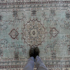 1970s pale green large turkish rug with medallion design, hand-knotted weave and low pile.