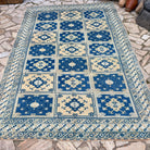 Blue 6' x 9' large turkish rug in wool and cotton, shown on the floor.