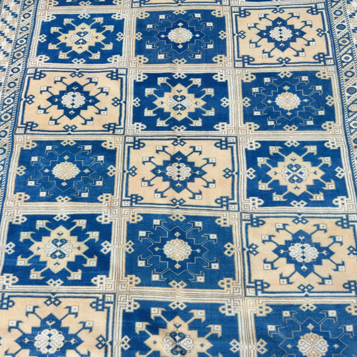 1970s blue large turkish rug with geometric design, hand-knotted weave and low pile.