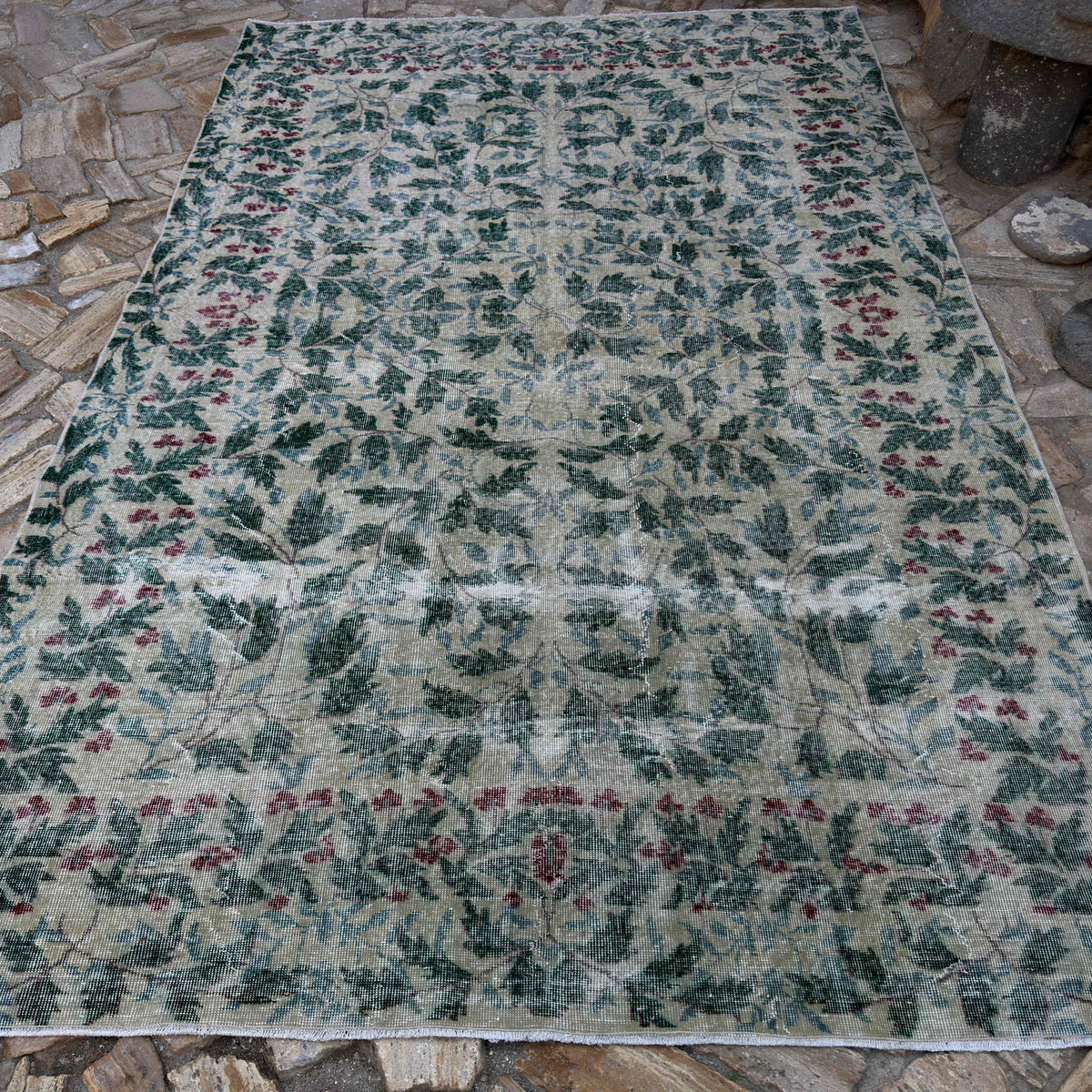 Green 7' x 10' large turkish rug in wool and cotton, shown on the floor.