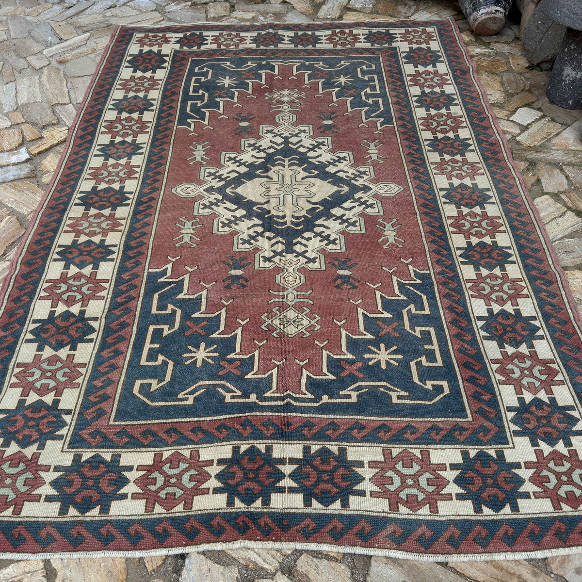 Pale Pink 7' x 10' large turkish rug in wool and cotton, shown on the floor.