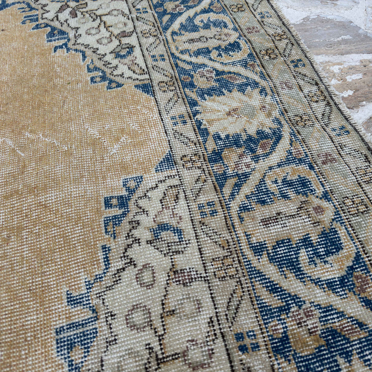 Close-up of the blue large turkish rug showing medallion details, hand-knotted weave, wool and cotton and low pile.
