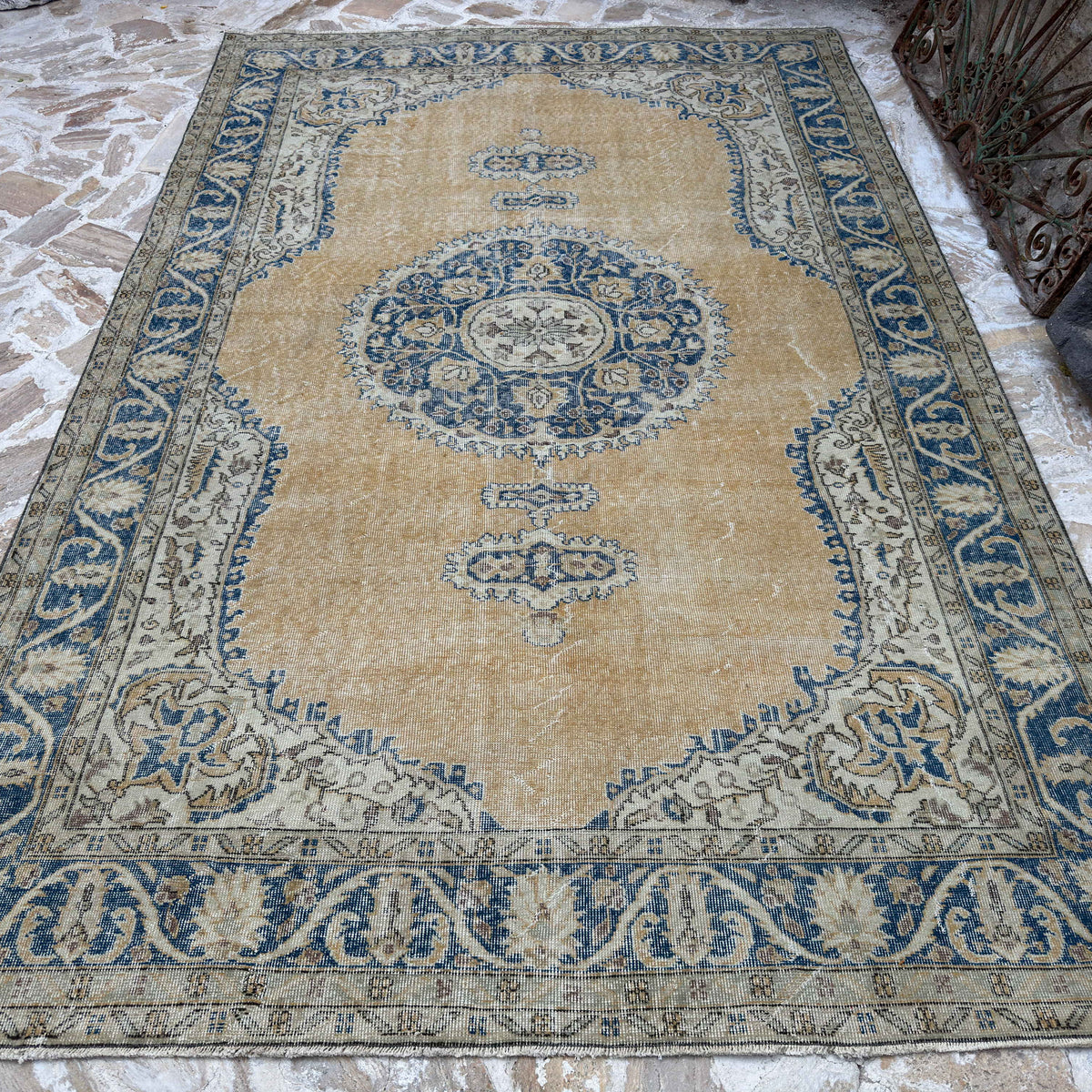 Blue 7' x 11' large turkish rug in wool and cotton, shown on the floor.