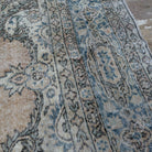 Close-up of the blue Turkish large vintage geometric rug showing medallion details, hand-knotted weave, wool and cotton and low pile.