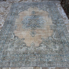 Blue 7' x 10' Turkish large vintage geometric rug in wool and cotton, shown on the floor.