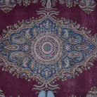 Burgundy 10' x 13' large vintage persian rug in wool and cotton, shown on the floor.