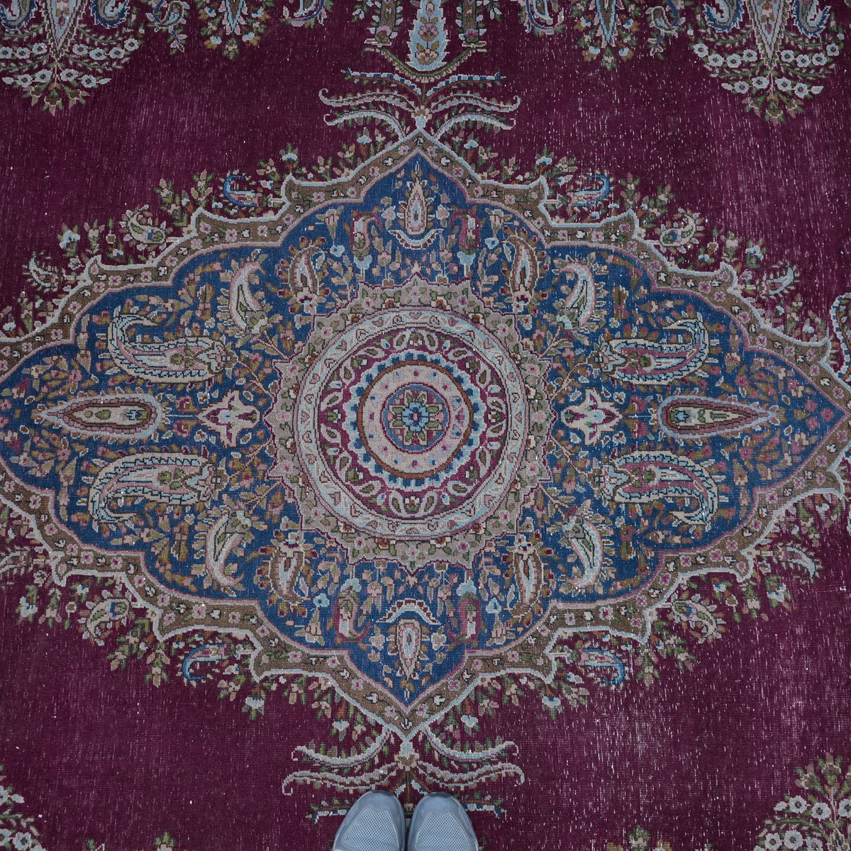 Burgundy 10' x 13' large vintage persian rug in wool and cotton, shown on the floor.