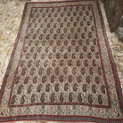 Beige 10' x 14' large vintage persian rug in wool and cotton, shown on the floor.
