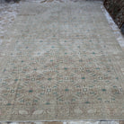 Beige 8' x 12' large vintage persian rug in wool and cotton, shown on the floor.